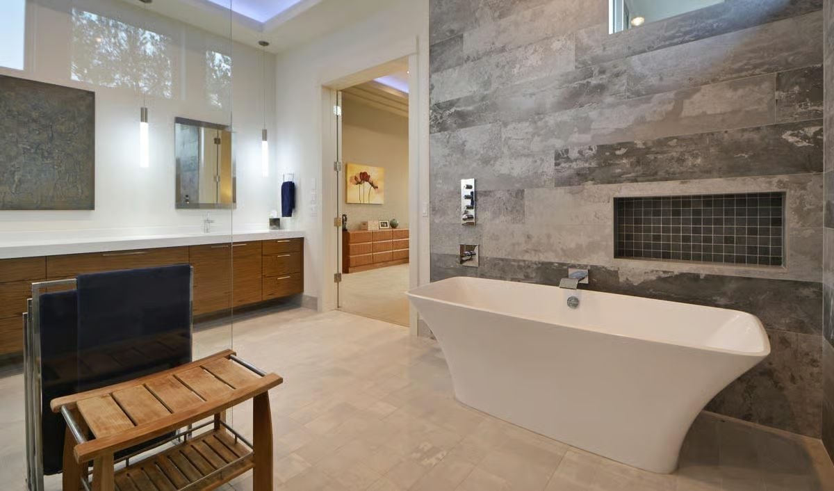 Freestanding Tub Against Raw Stone Makes the Bath Feel Like a Different Building