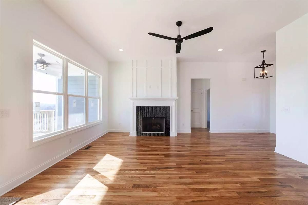 Herringbone Tile and Board-and-Batten Make This Fireplace Worth Centering a Room Around