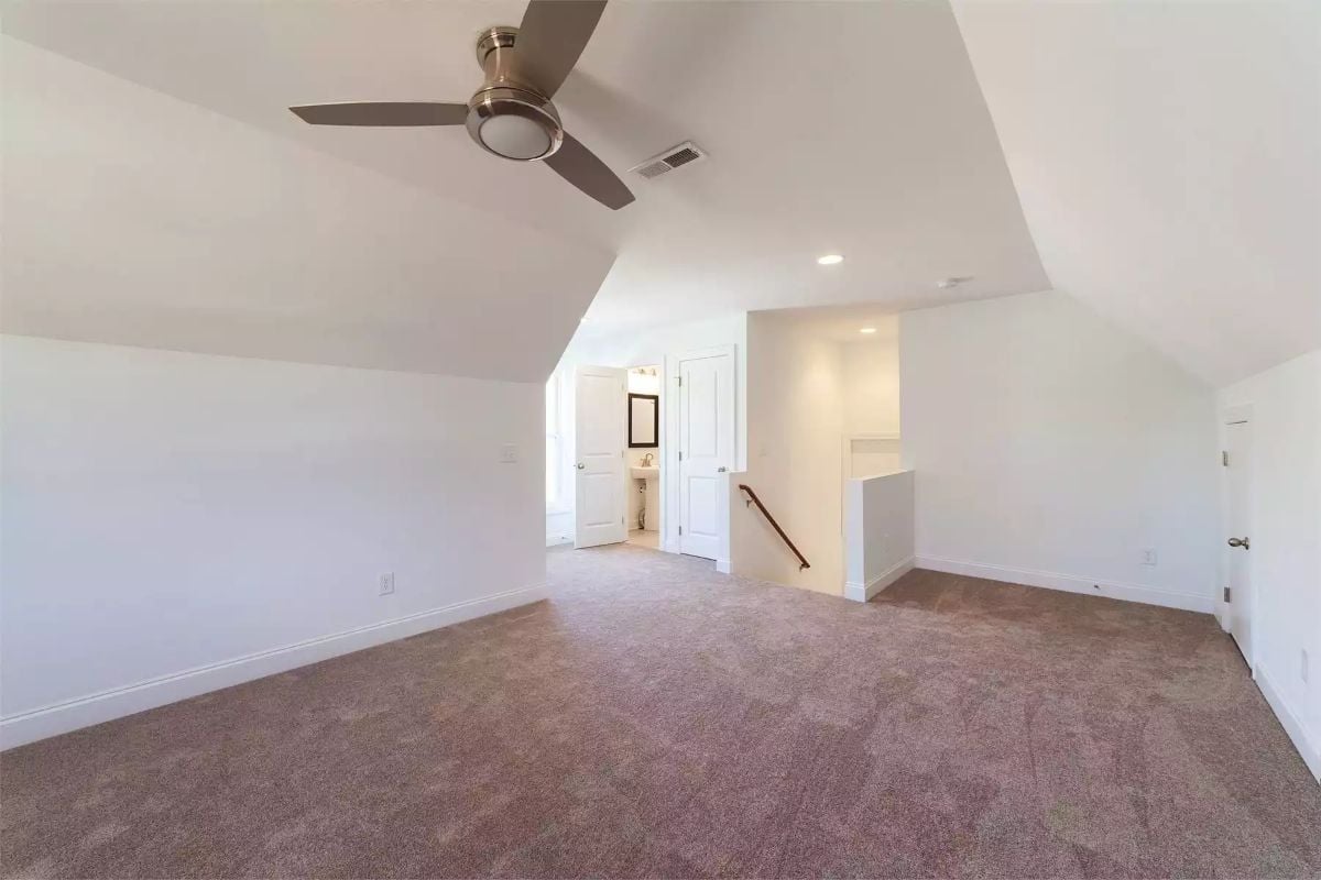 Vaulted Bonus Room with Carpet and a Ceiling Fan That Keeps Things Livable
