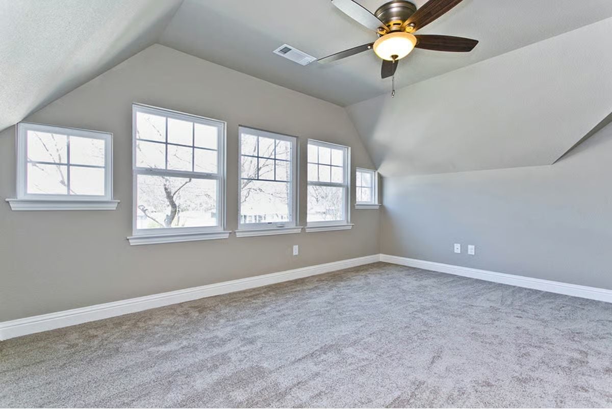 Vaulted Ceiling and Three Windows Make an Empty Room Feel Like a Decision