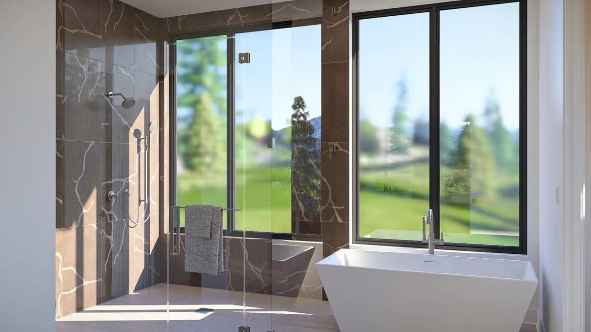 Marble-Clad Shower and a Soaking Tub Positioned to Catch the Green Below