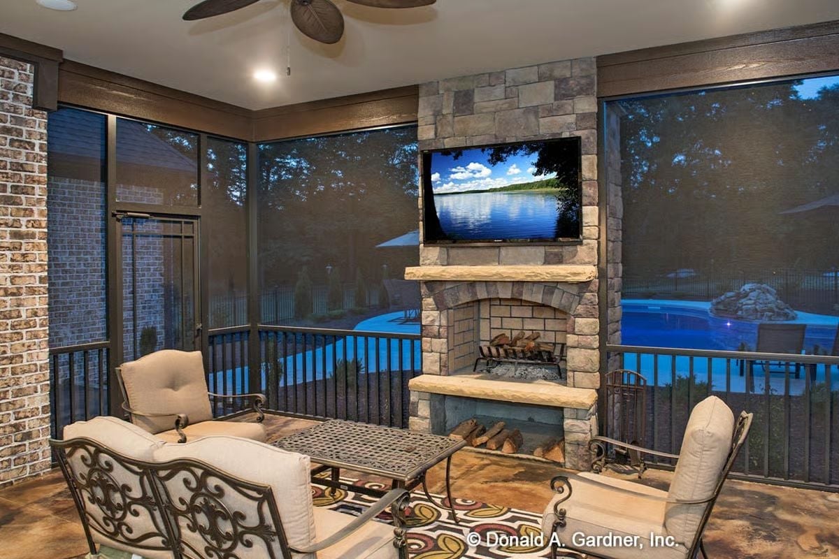 Screened Porch with Stone Fireplace and Pool View Gets Used Every Single Month of the Year
