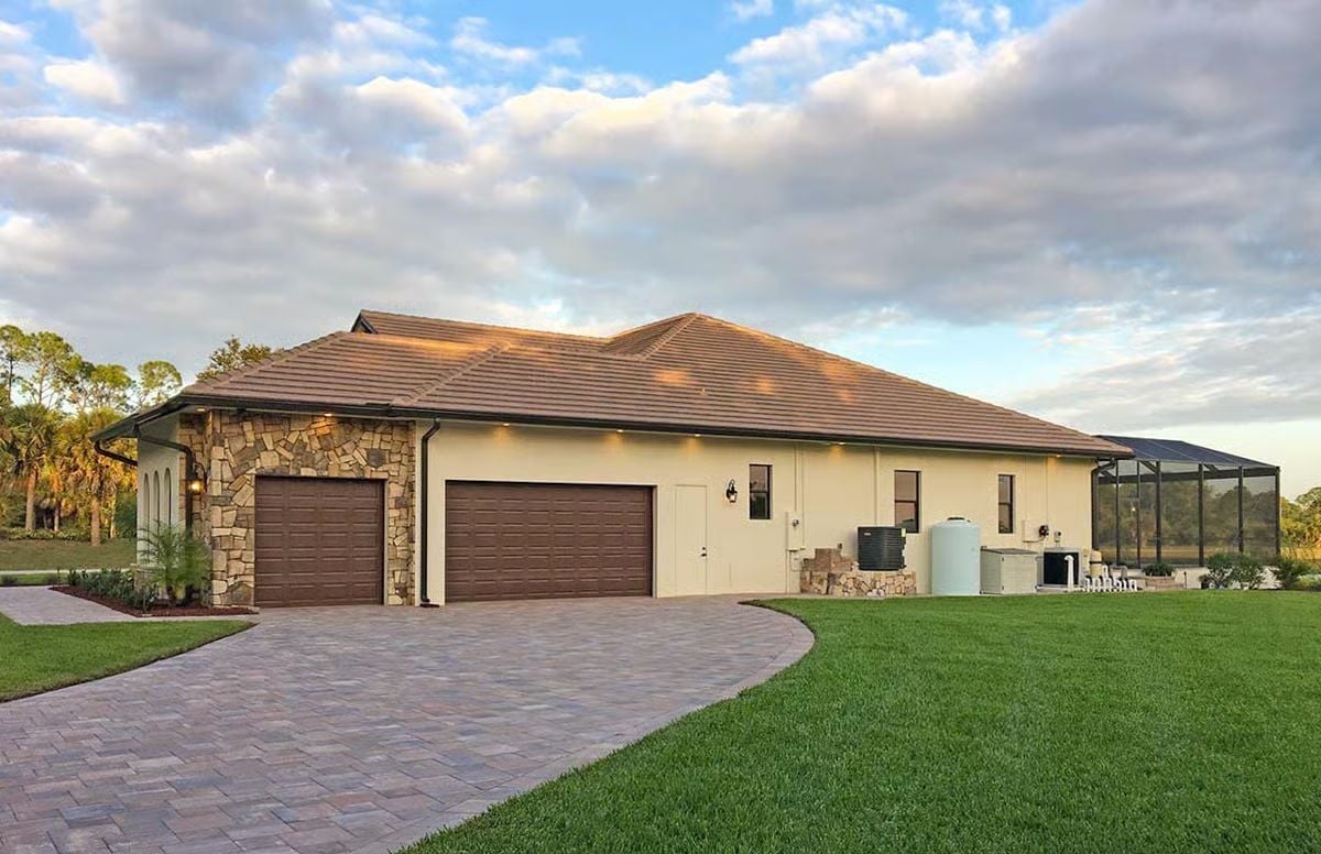 Stone Accent, Screened Lanai, and a Driveway That Means Business