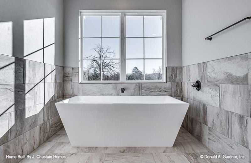 Freestanding Tub, Wall-Mount Faucet, and Marble Tile That Pulls It All Together