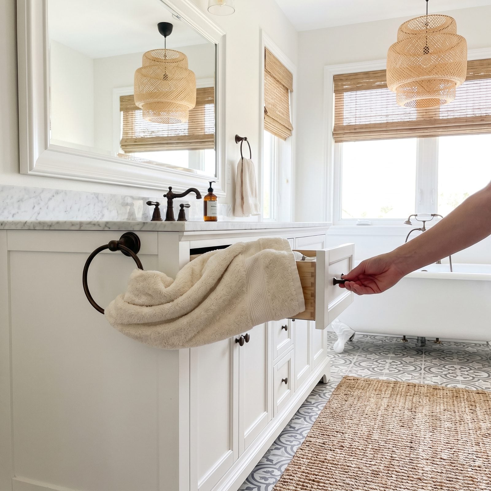 Oak vanity where a wall-mounted towel ring blocks the drawer beside it from opening fully.