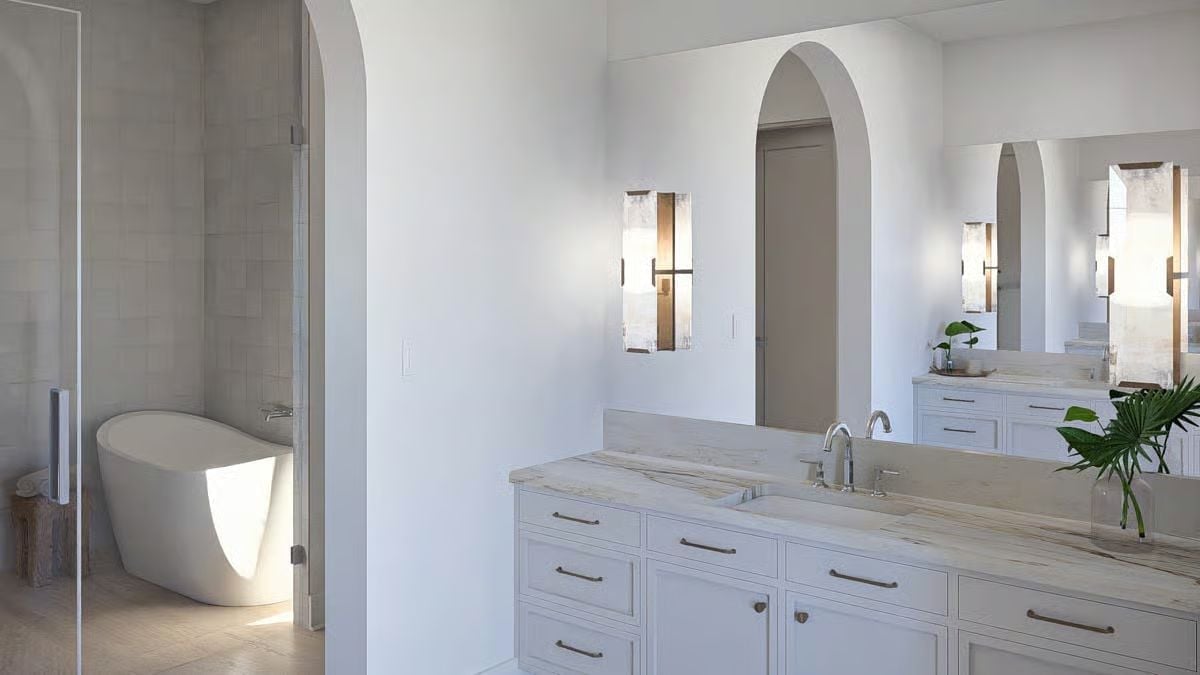 Freestanding Tub Through a Glass Door, Arched Mirror, and a Vanity That Goes the Distance