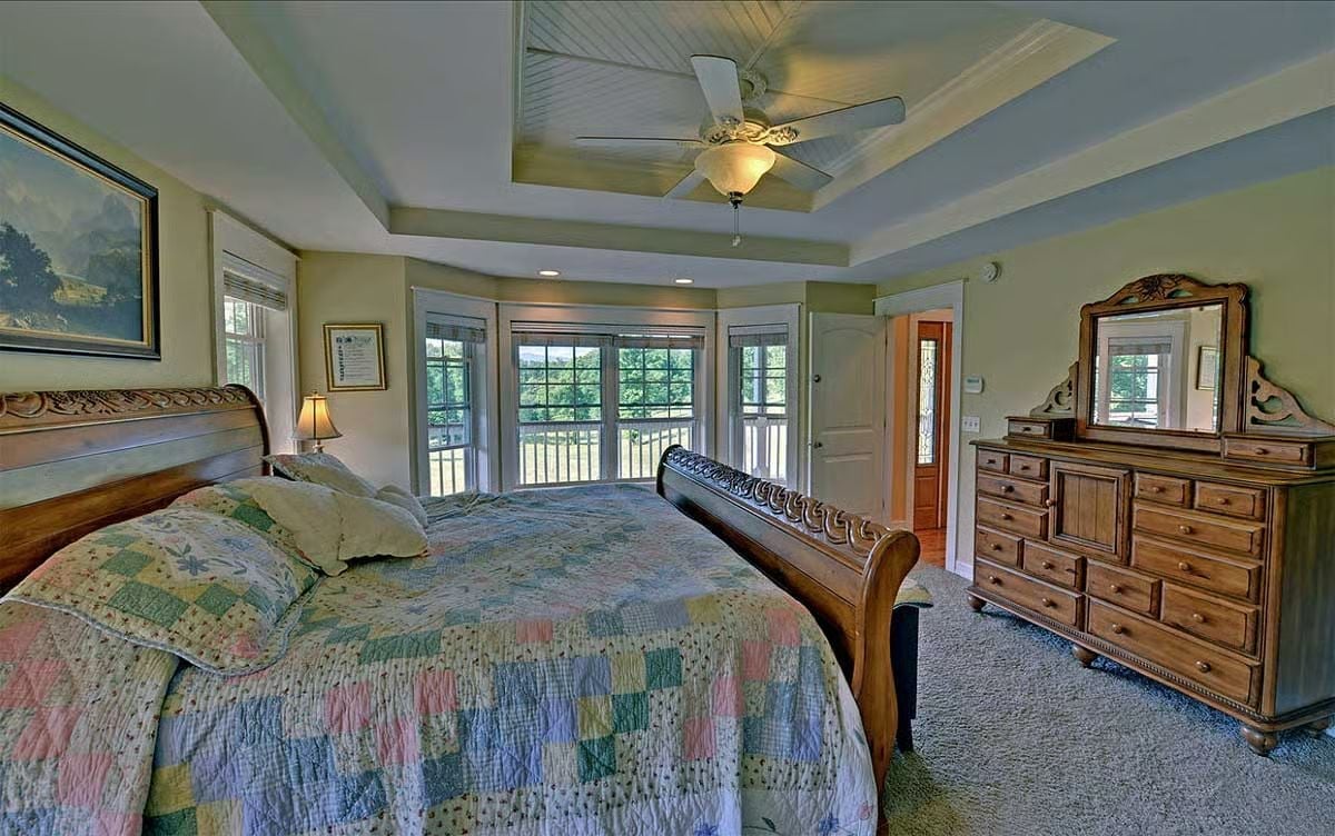 Carved Sleigh Bed, Bay Windows, and a Ceiling Fan That Earns Its Place