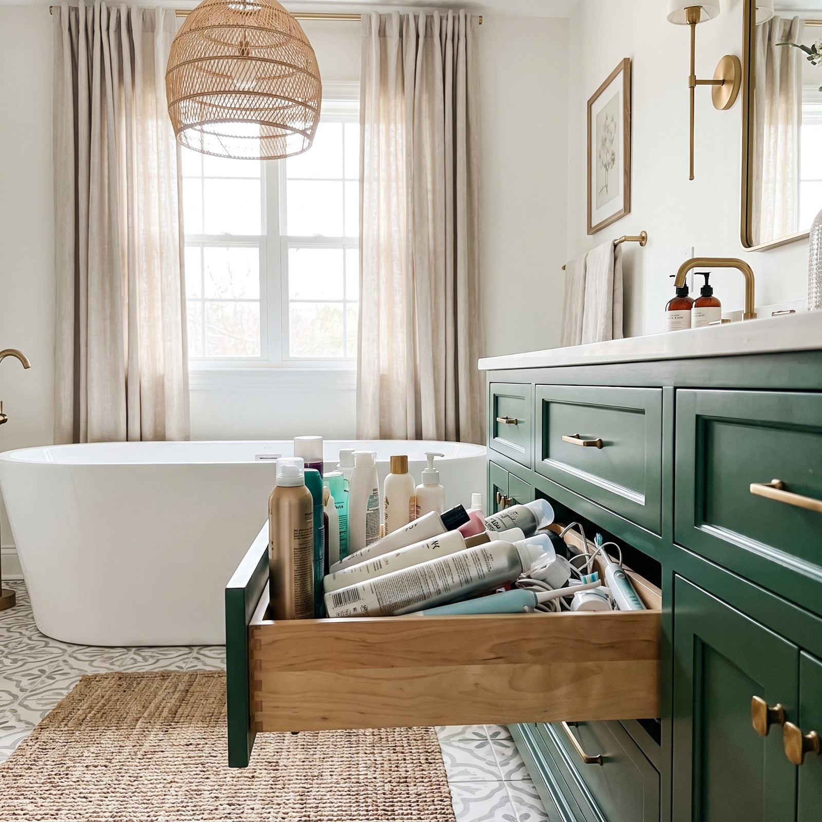 Shallow bathroom drawer with an electric toothbrush and hairspray lying flat because nothing tall fits upright.