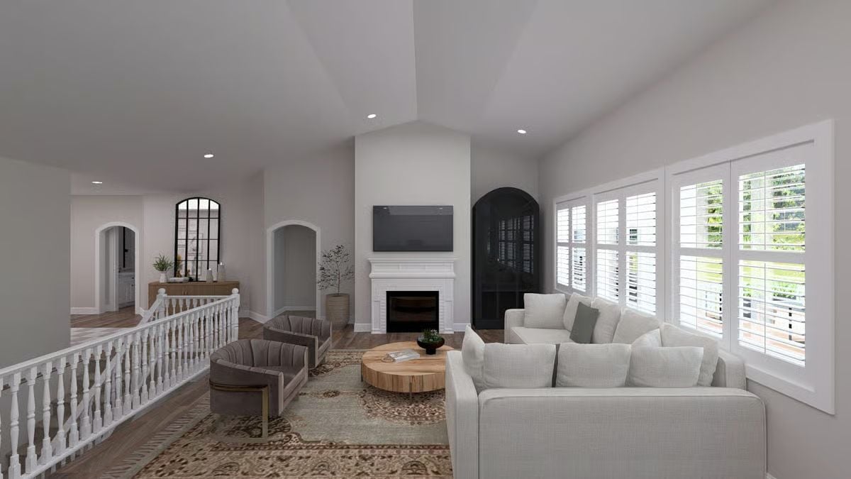 Vaulted Ceiling and White Fireplace Wall Make the Living Room Feel Like the Whole Point