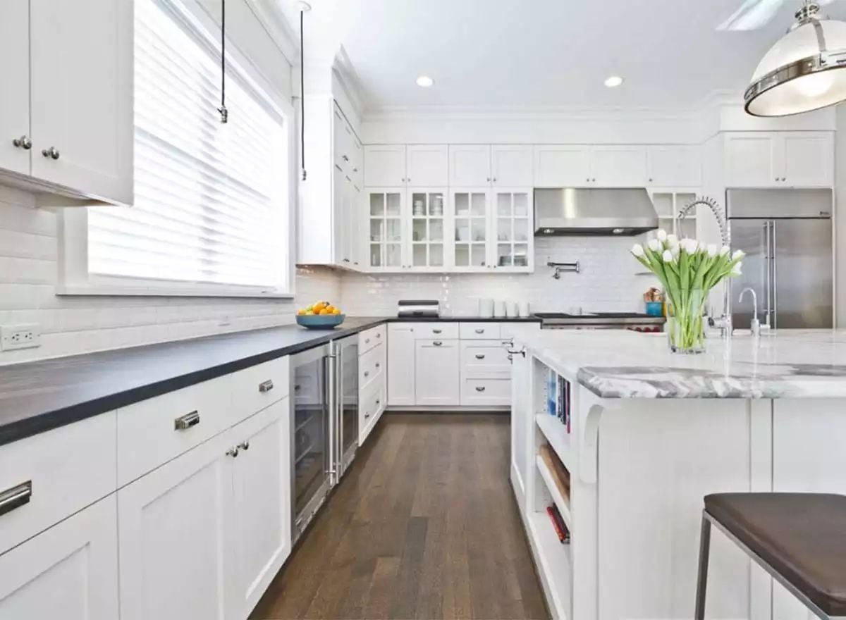 Black Countertops Against White Cabinets Keep This Kitchen Honest