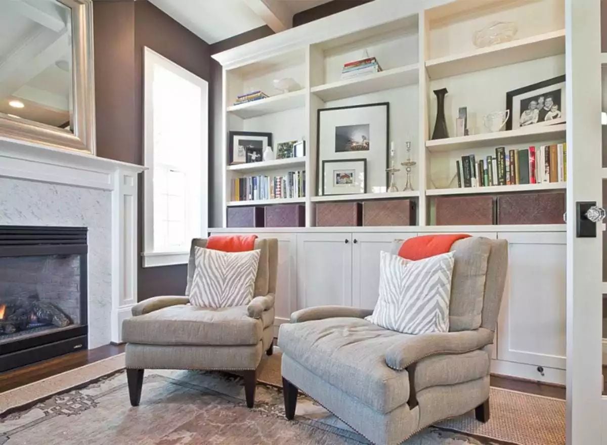 Built-Ins, a Fireplace, and Two Chairs That Invite You to Stay Awhile