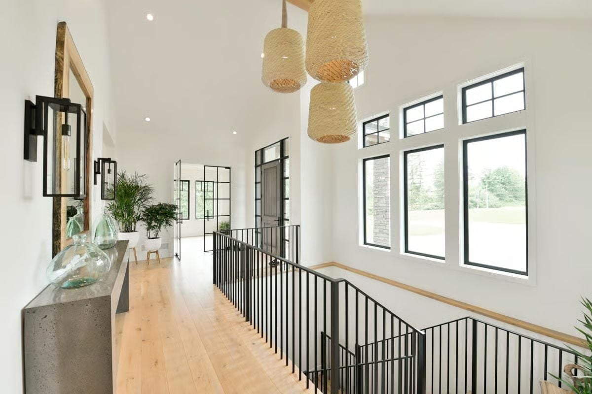 Woven Pendants and Black Steel Rails on a Second-Floor Hallway Worth the Walk