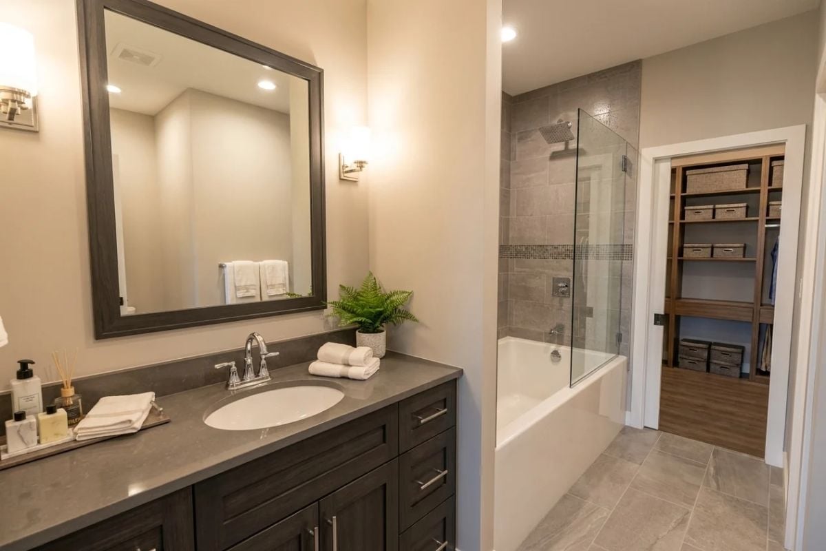 Quartz Counters and a Glass-Panel Tub Surround Make a Modest Footprint Feel Generous