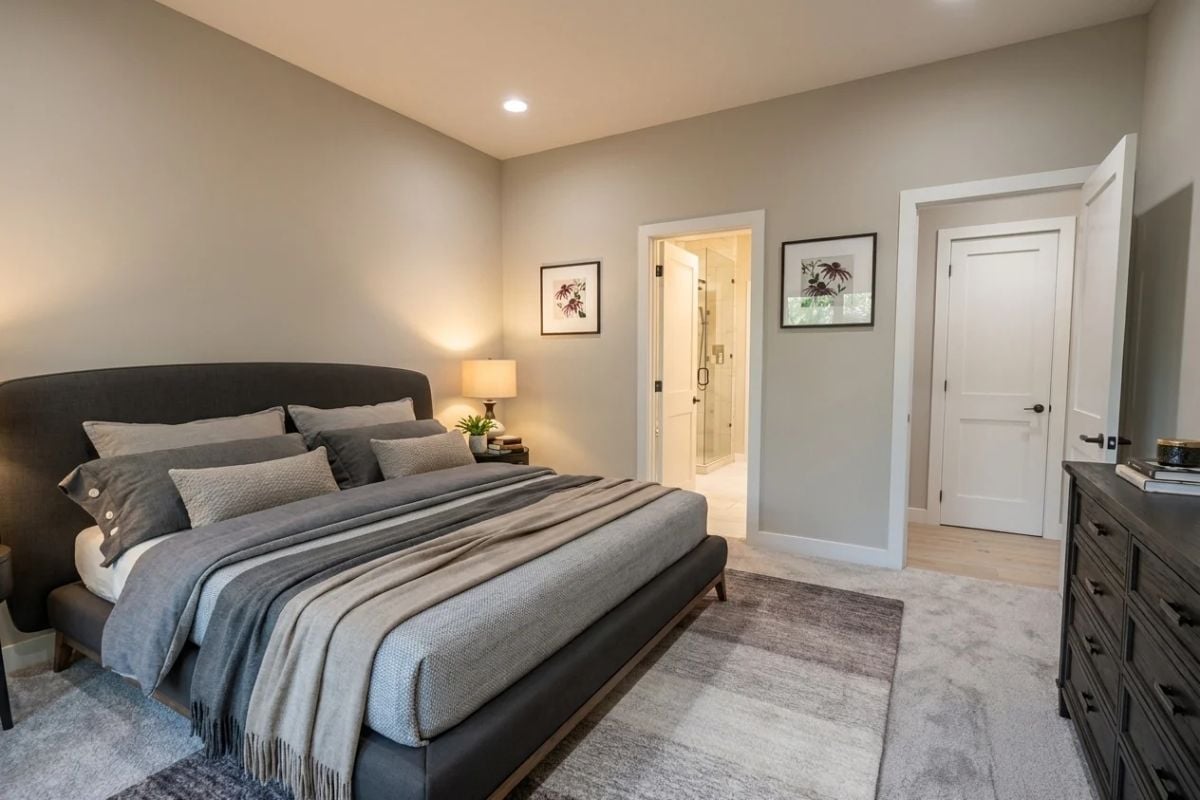 Gray Layered Bedding, an En Suite Door, and a Dresser That Pulls Its Weight