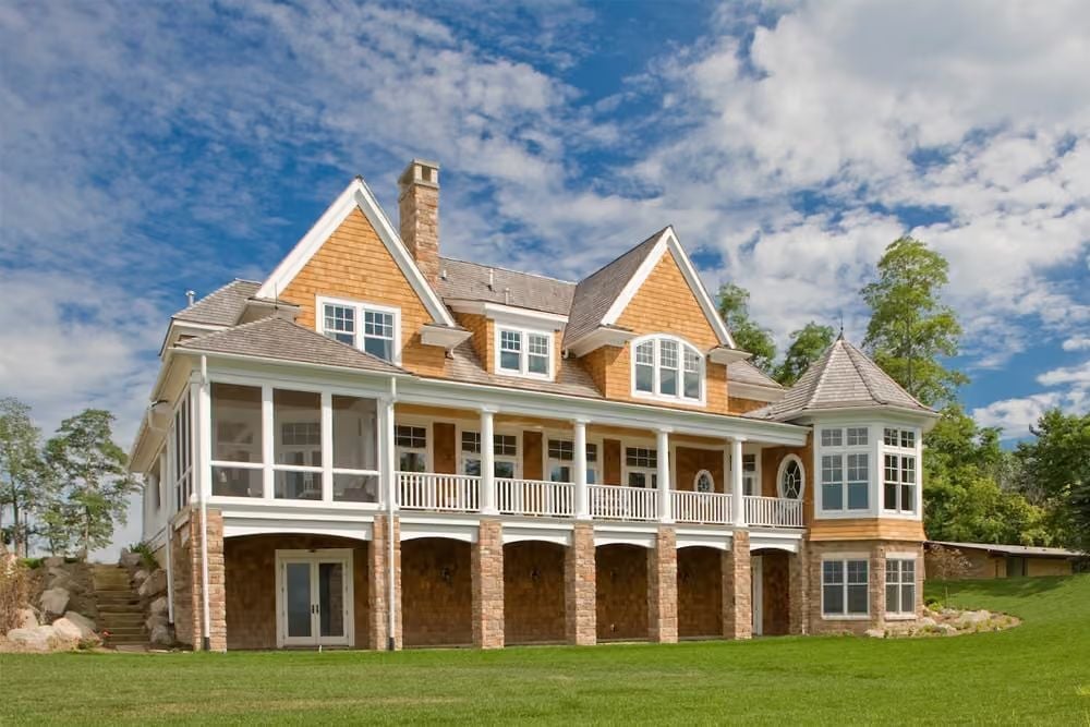 Cedar Shingles and Arched Stone Base Make This the Lake House Everyone Remembers