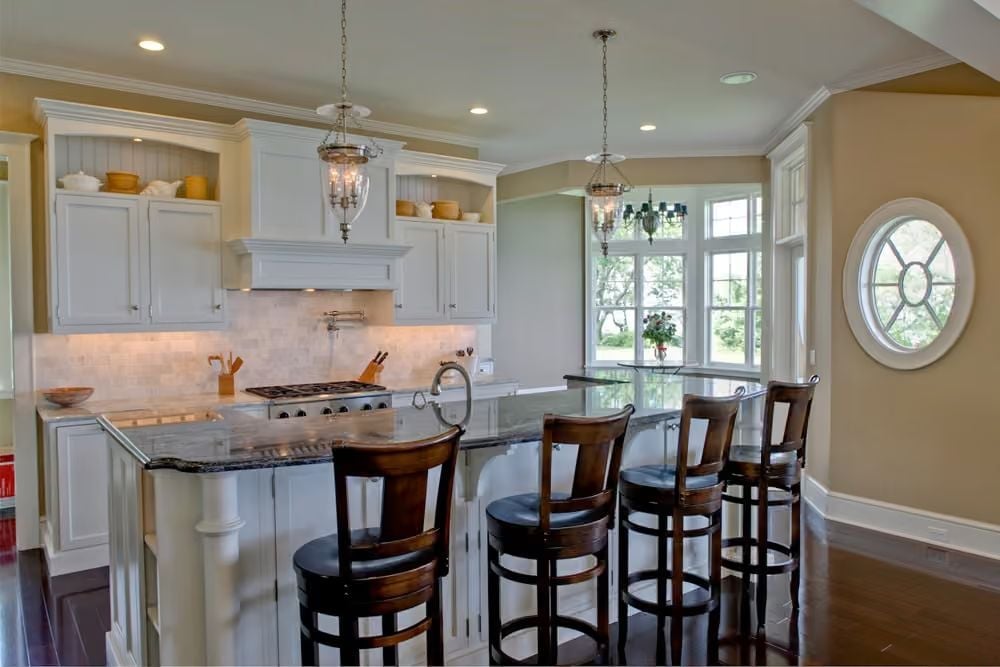 Pendant Lanterns and Dark Granite Pull This Kitchen in Two Directions at Once