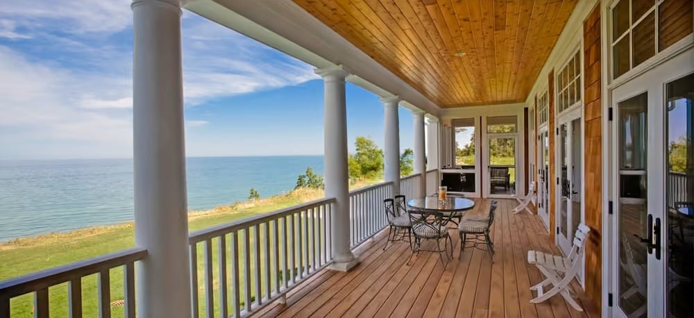 Wraparound Porch With Column Row and Cedar Ceiling Earns Its Keep Year-Round