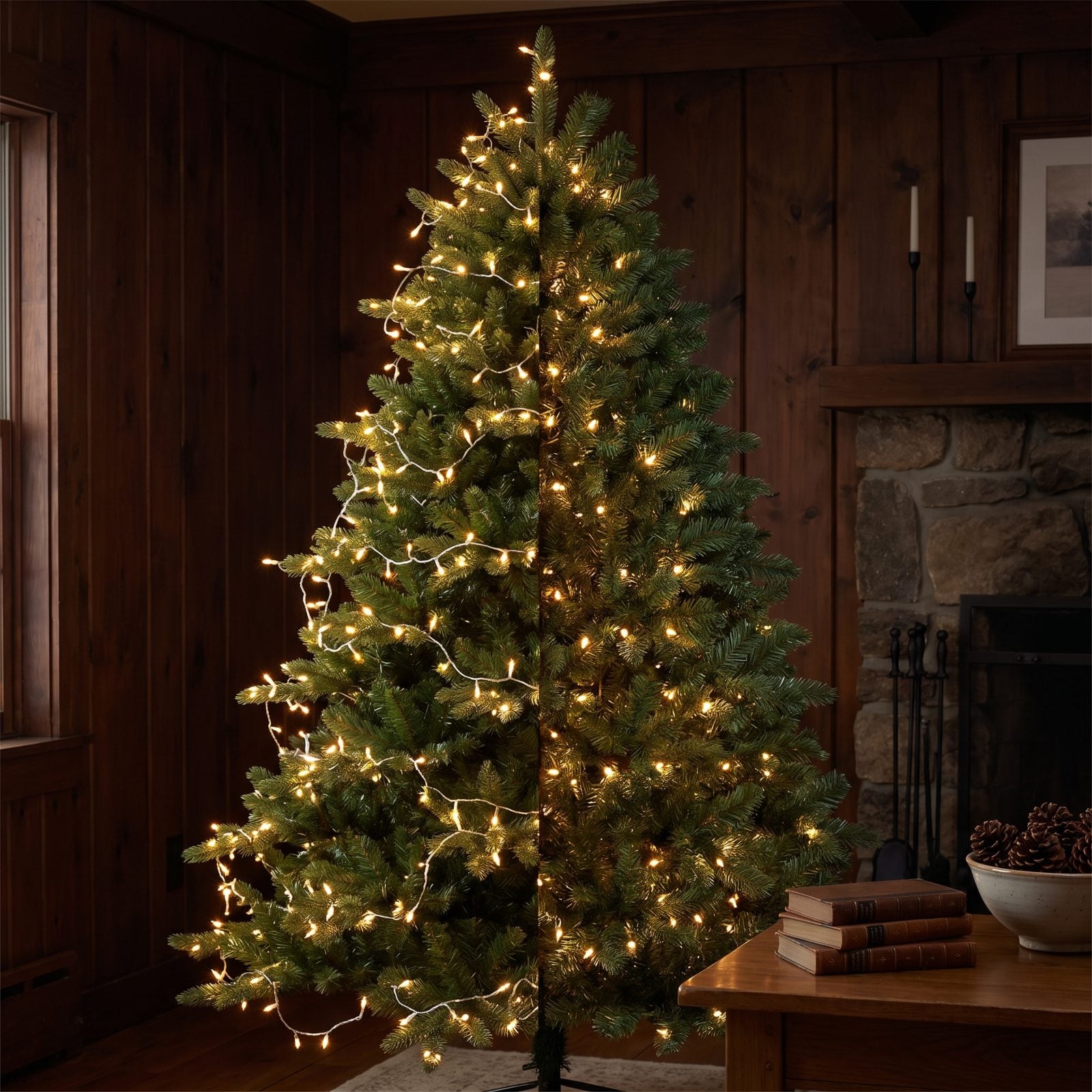 Artificial tree lit only on the outer branch tips with a dark, flat unlit interior near the trunk.