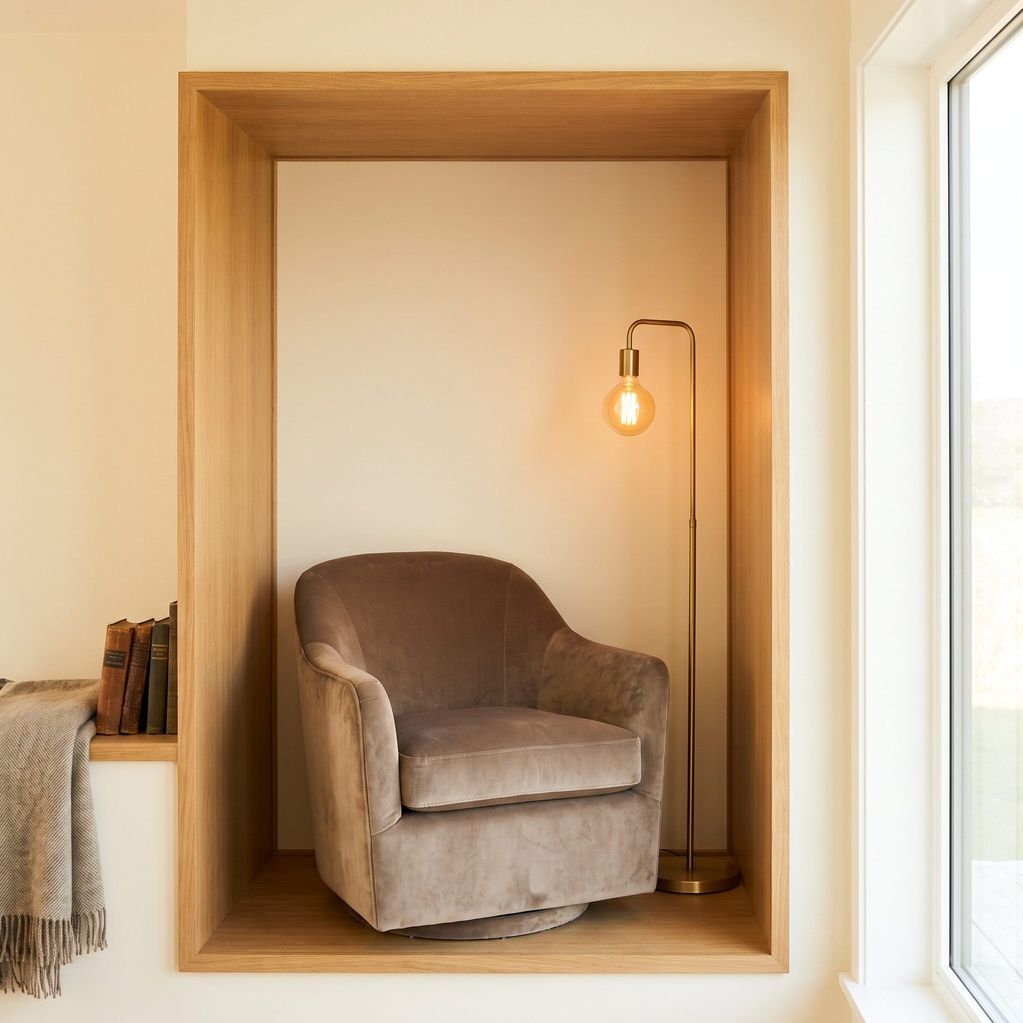 Bedroom reading nook with a swivel chair tucked inside an L-shaped wall projection