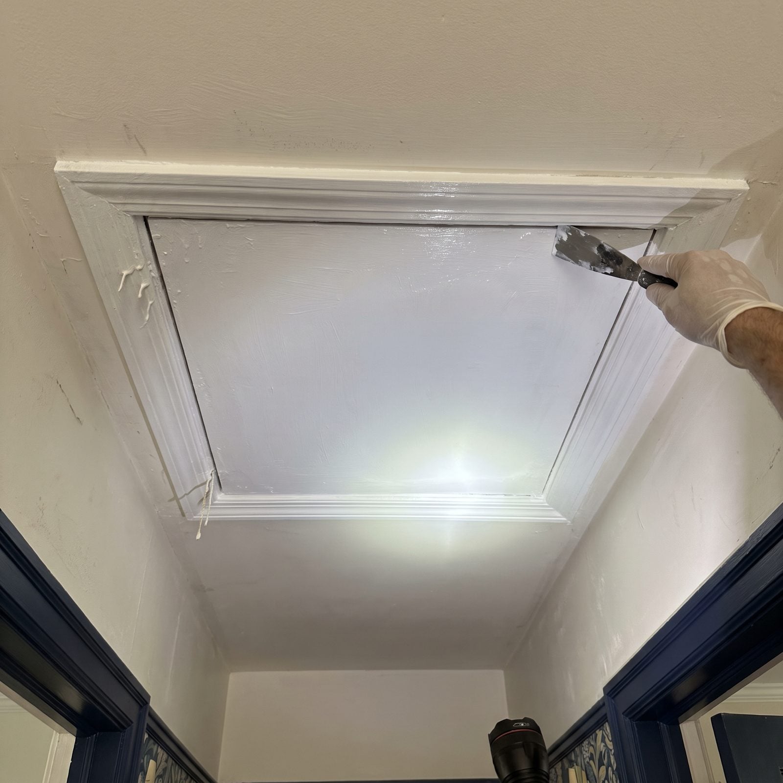 An Attic Hatch Sealed Shut With Fresh Paint