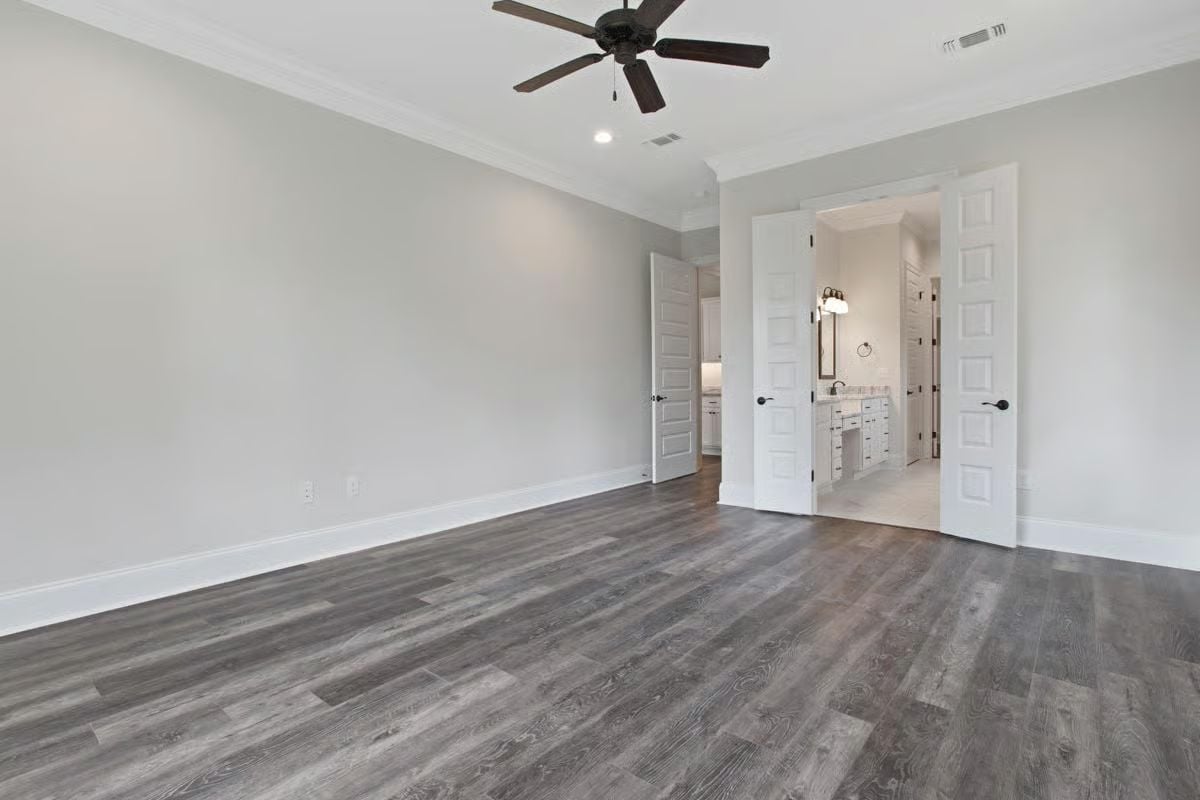 Crown Molding and Dark Floors in a Primary Suite That's Ready to Furnish
