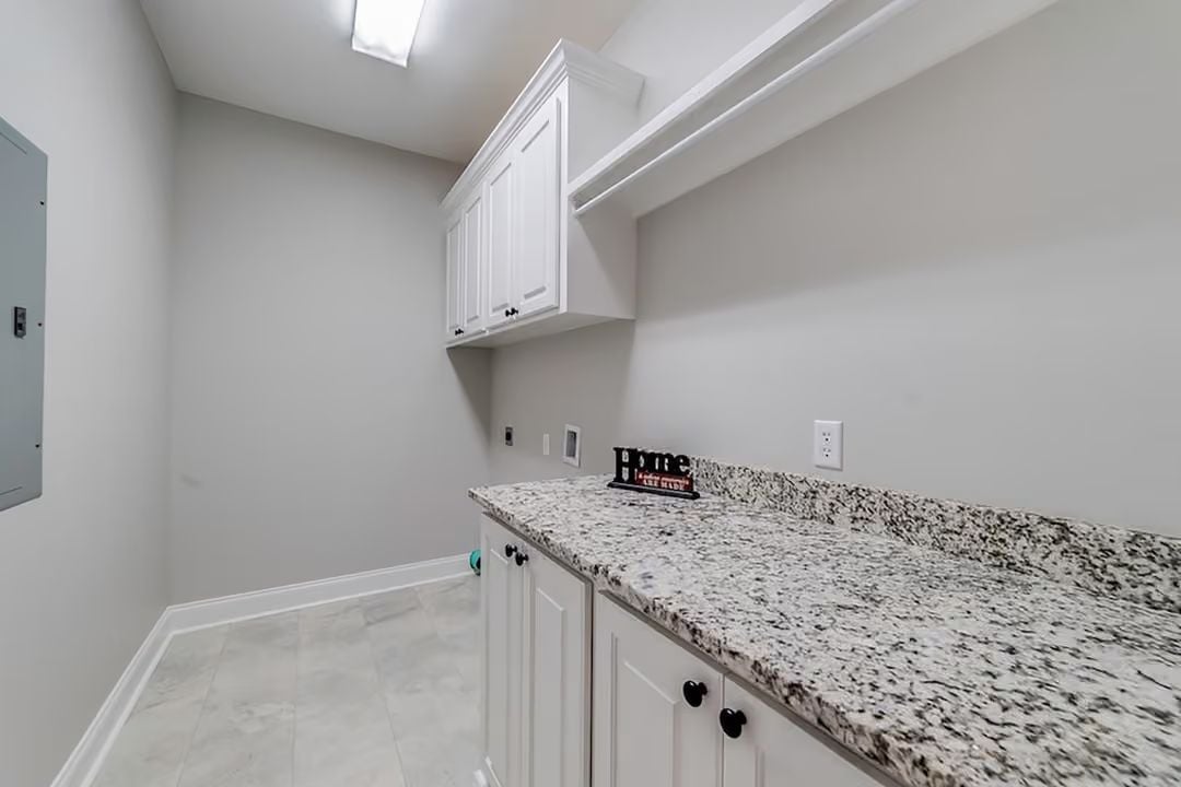 Granite Counters and White Cabinetry Built for Laundry Day and Beyond