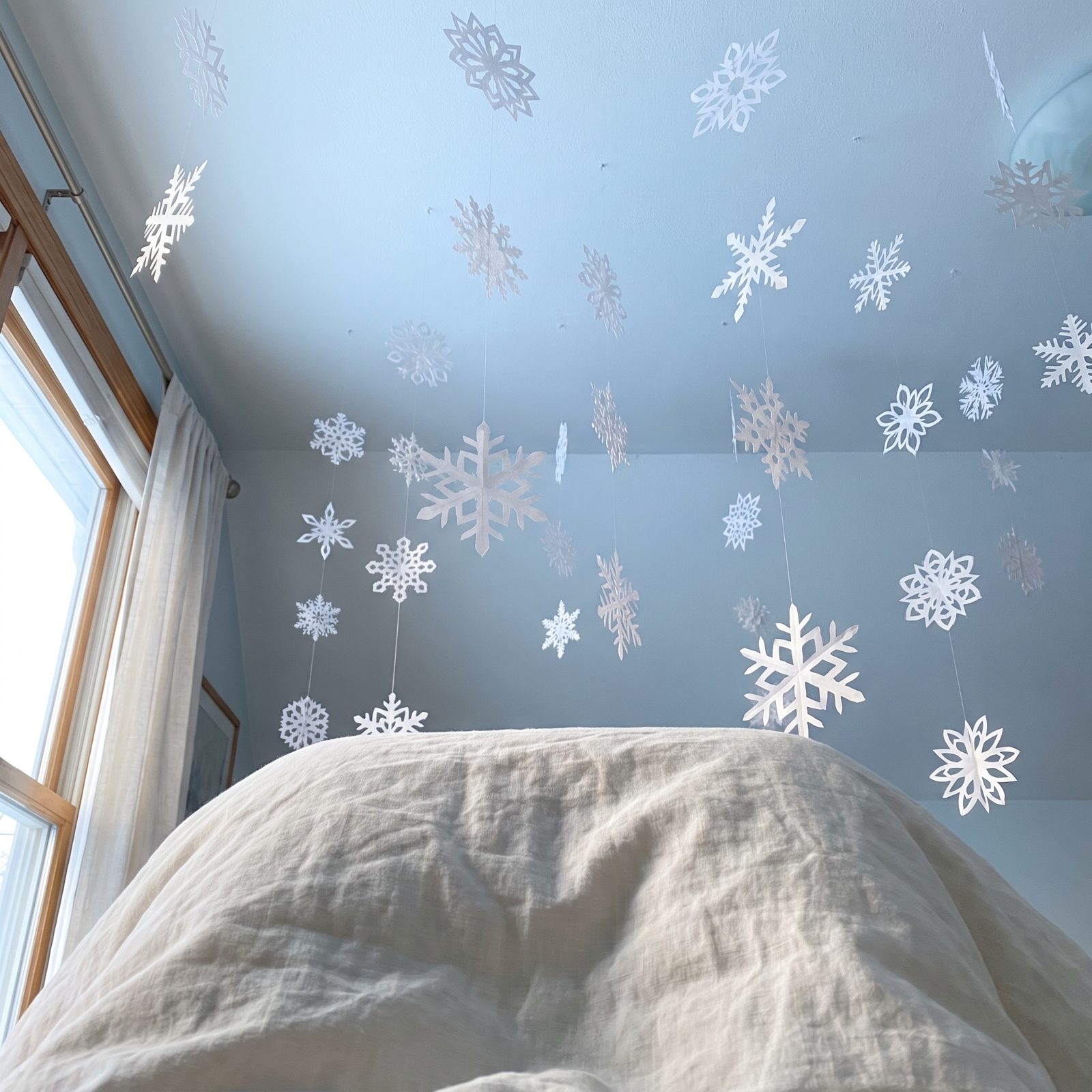 A Bedroom Under a Constellation of Paper Snowflakes