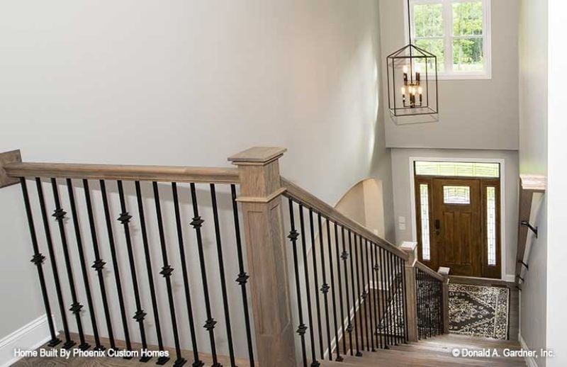 Wood Handrails, Iron Balusters, and a Two-Story Drop That Commands Attention