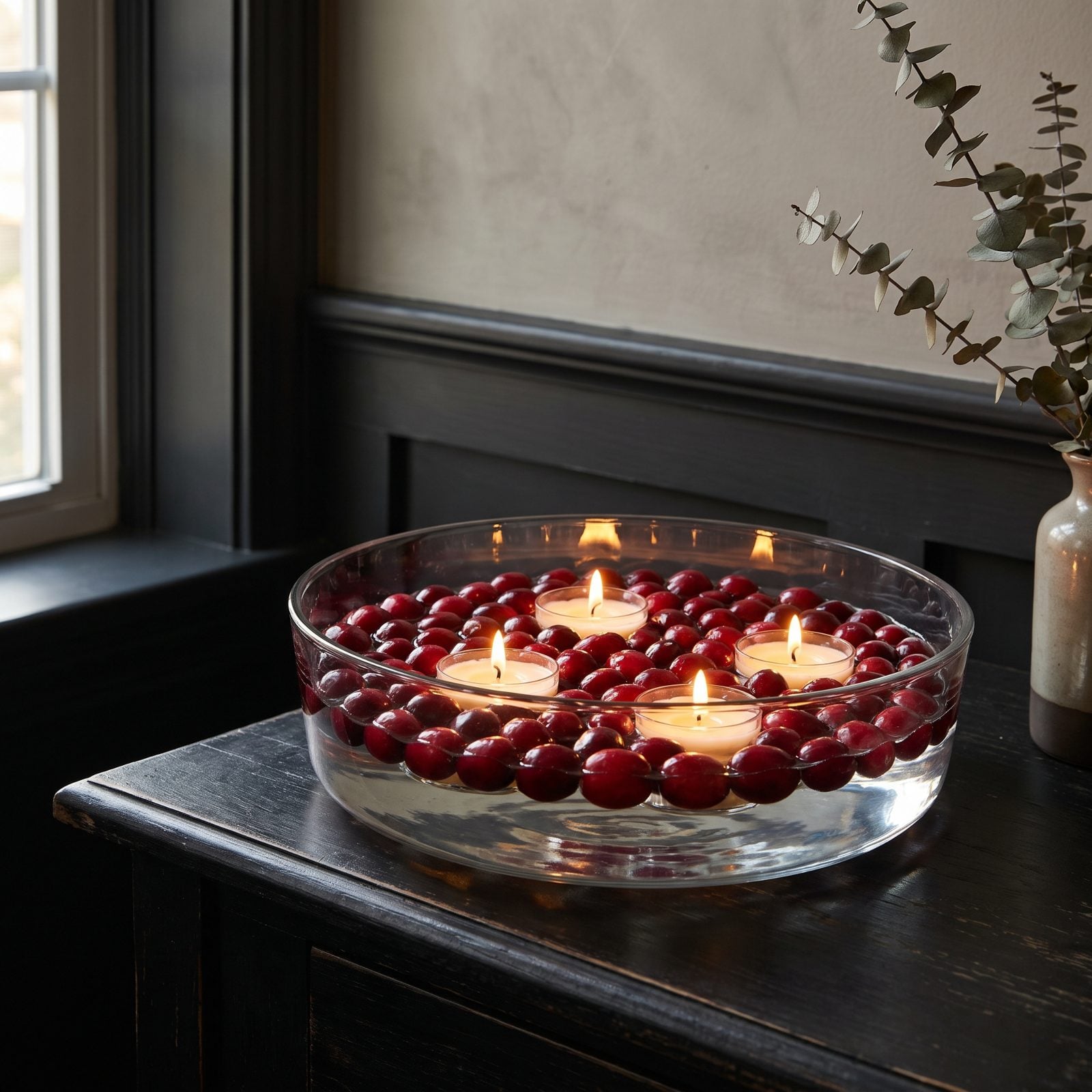 A Bowl of Floating Cranberries and Candlelight