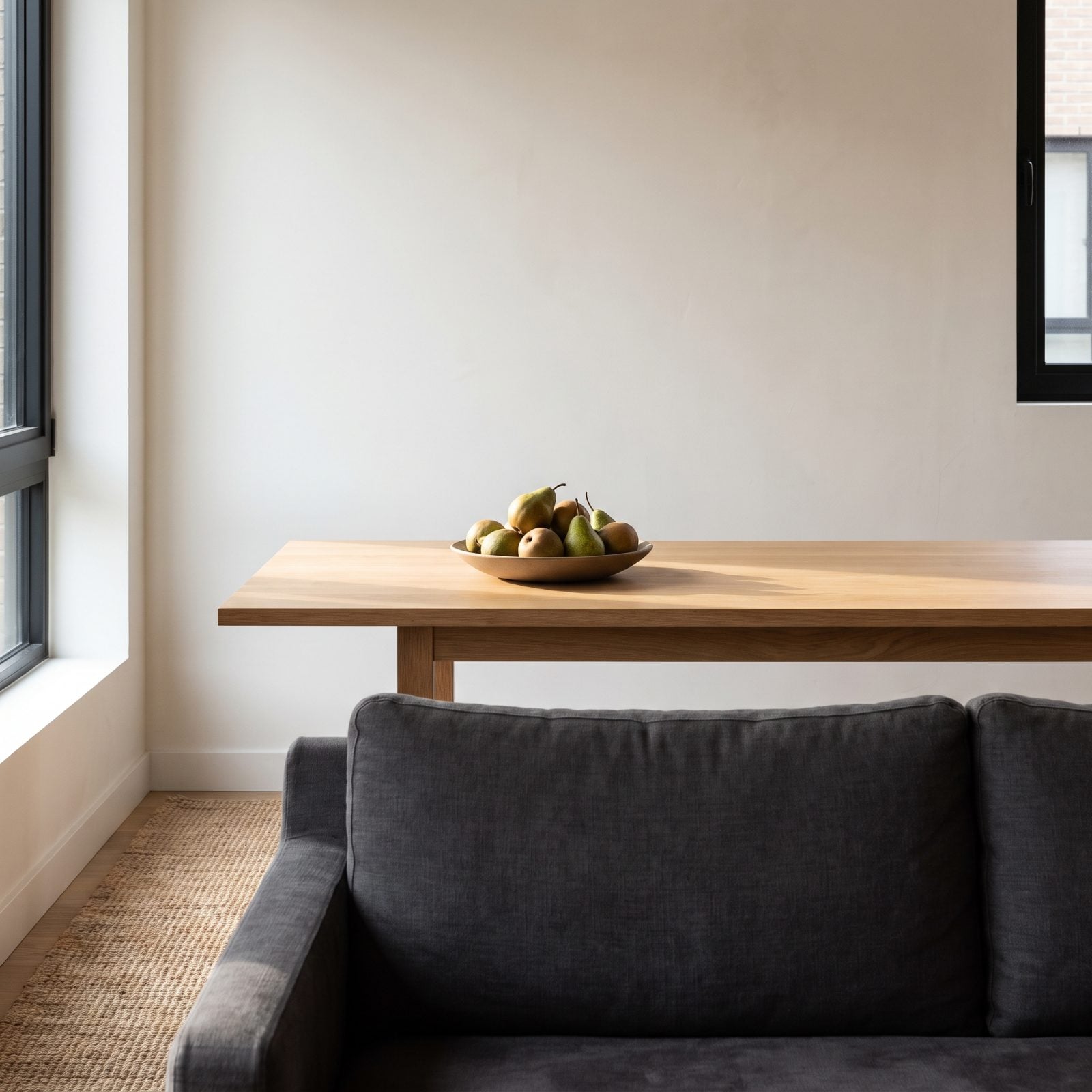 A Bowl of Winter Pears on an Otherwise Bare Table