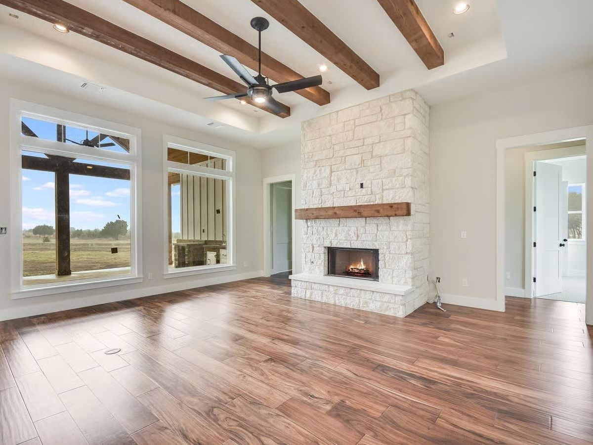 Limestone Fireplace with a Raw Wood Mantel Sets the Whole Room's Tone