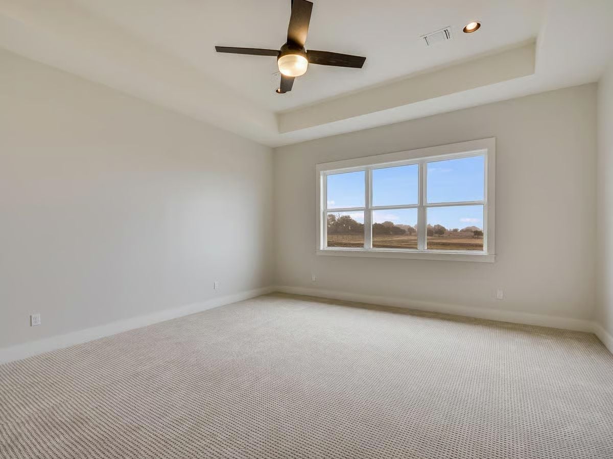 Tray Ceiling and Pasture Views Give the Primary Bedroom Its Quiet Authority