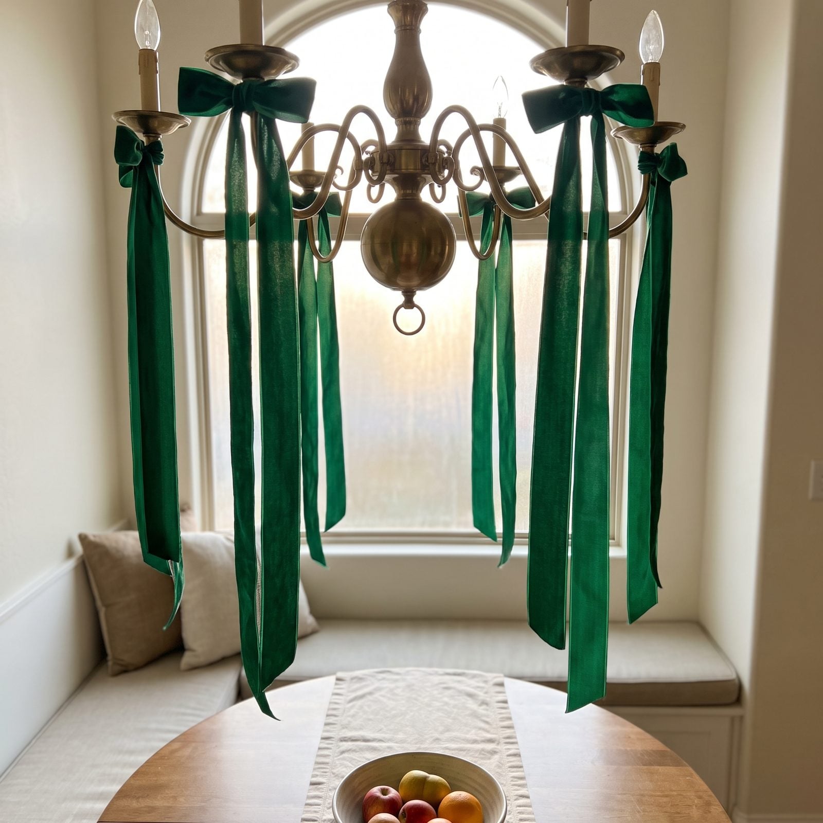 A Breakfast Nook Chandelier Tied With Velvet Bows