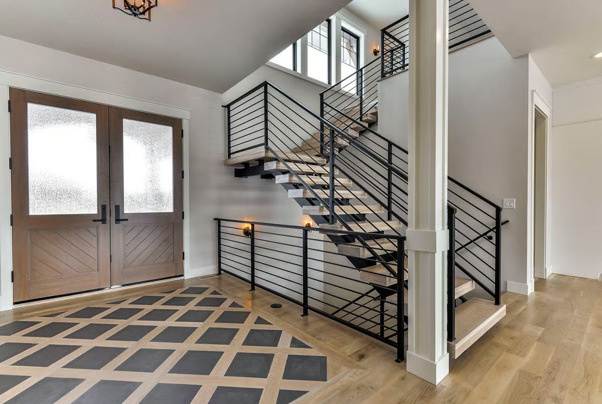Floating Stairs and a Geometric Entry Floor That Make the First Impression Count