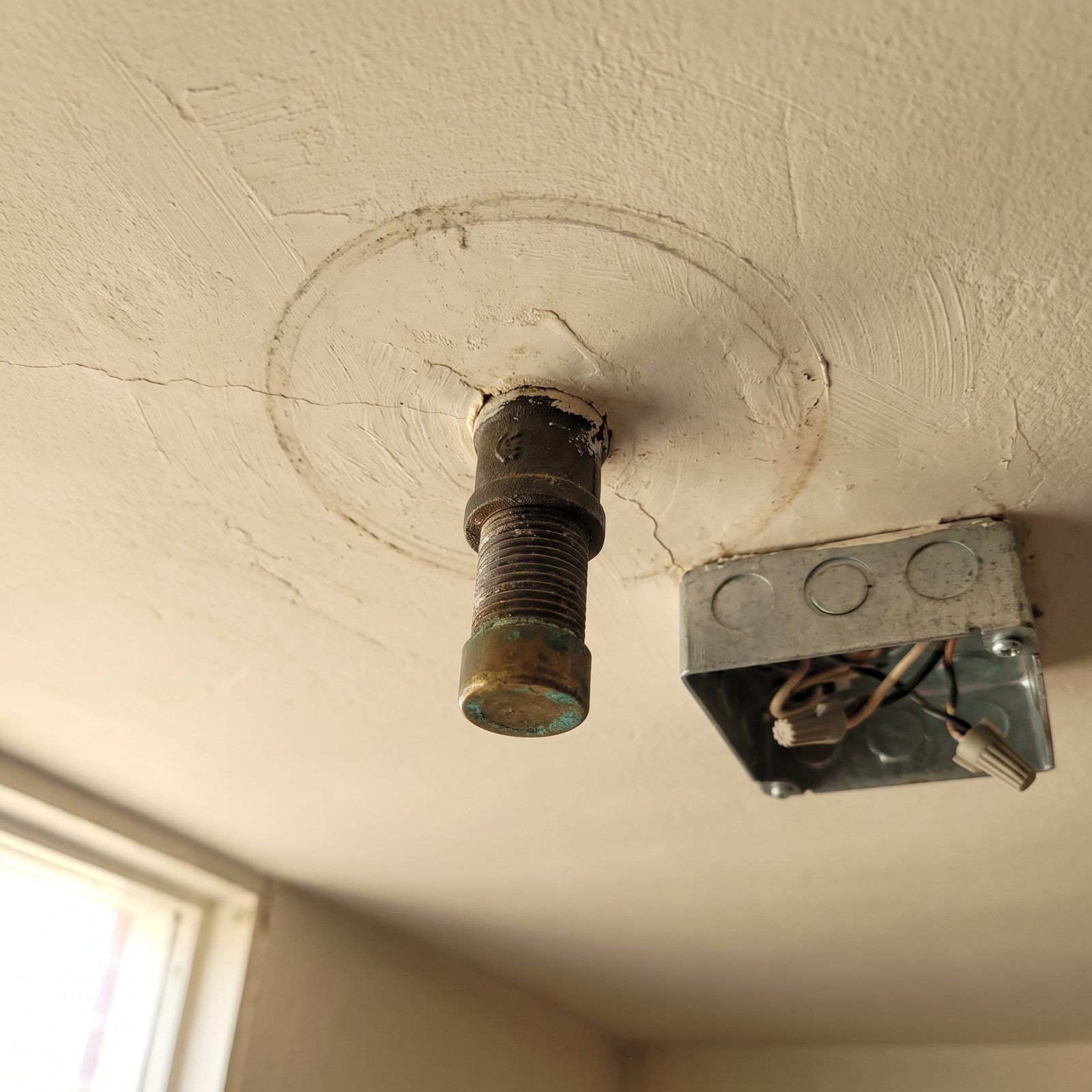 Capped Gas Pipes Near Ceiling Fixtures