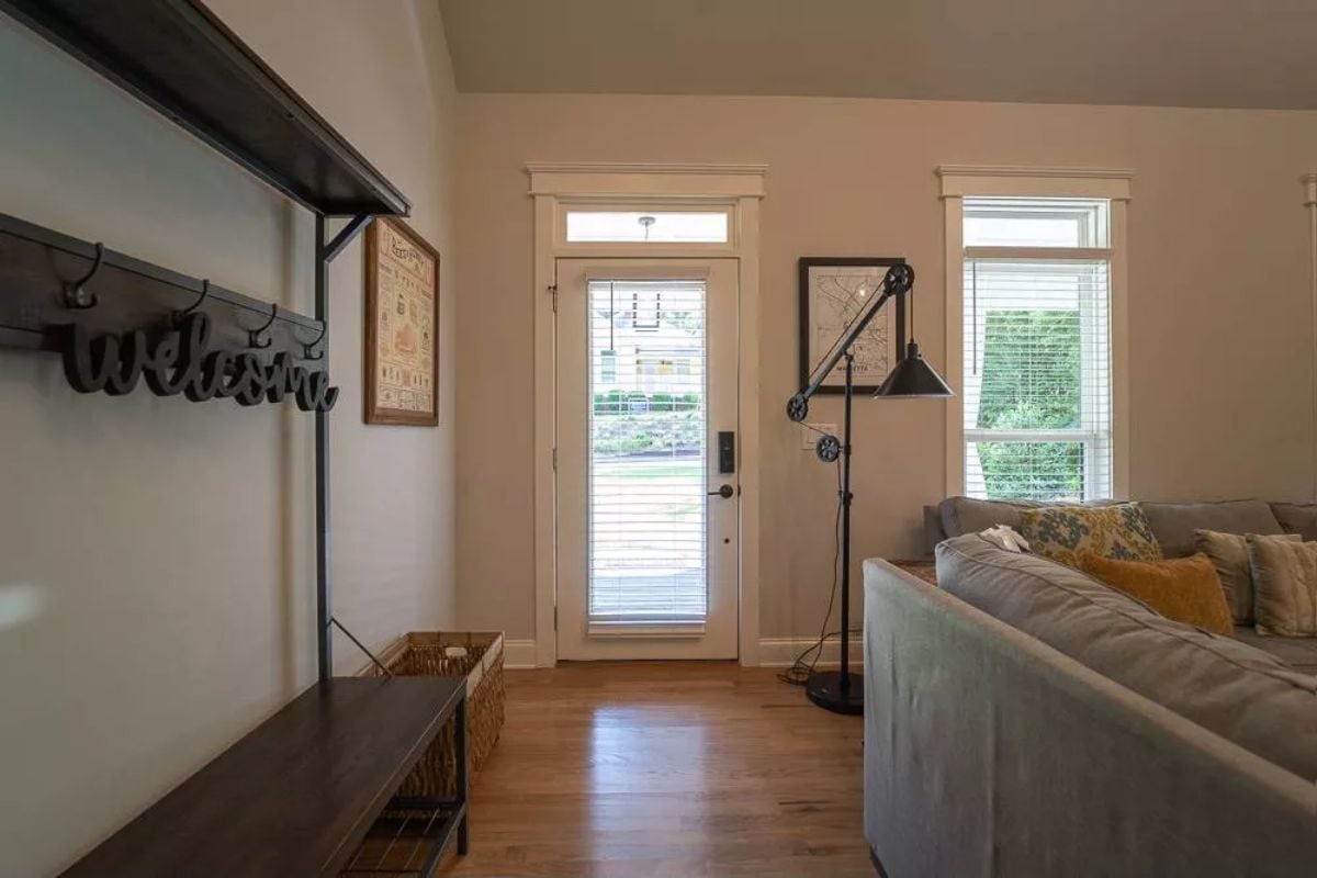 Industrial Floor Lamp, Yellow Pillows, and a Welcome Sign That Means It