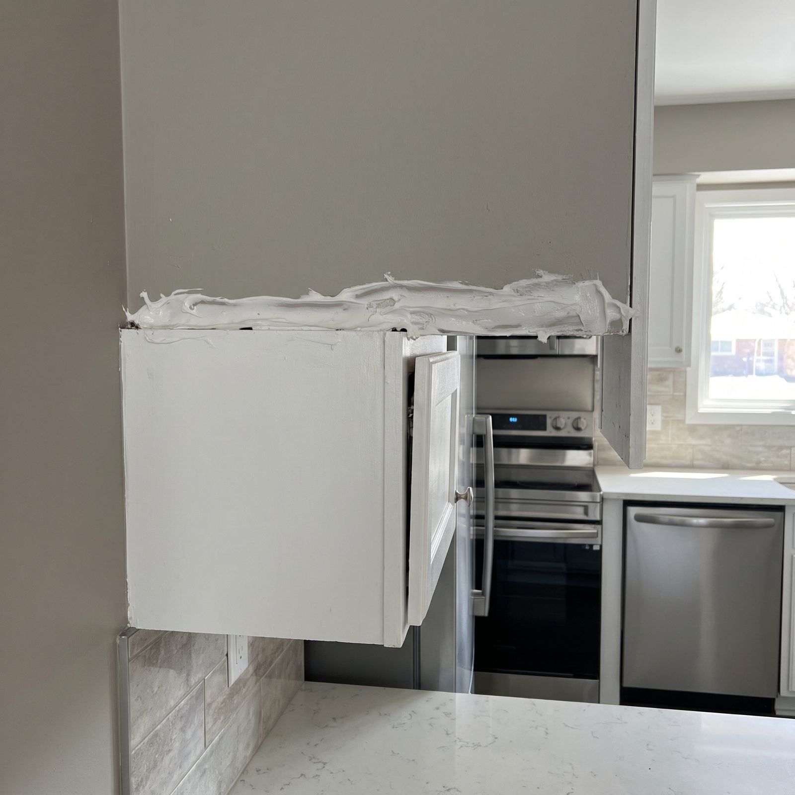 Caulk Hiding Gaps Between Cabinets and Walls