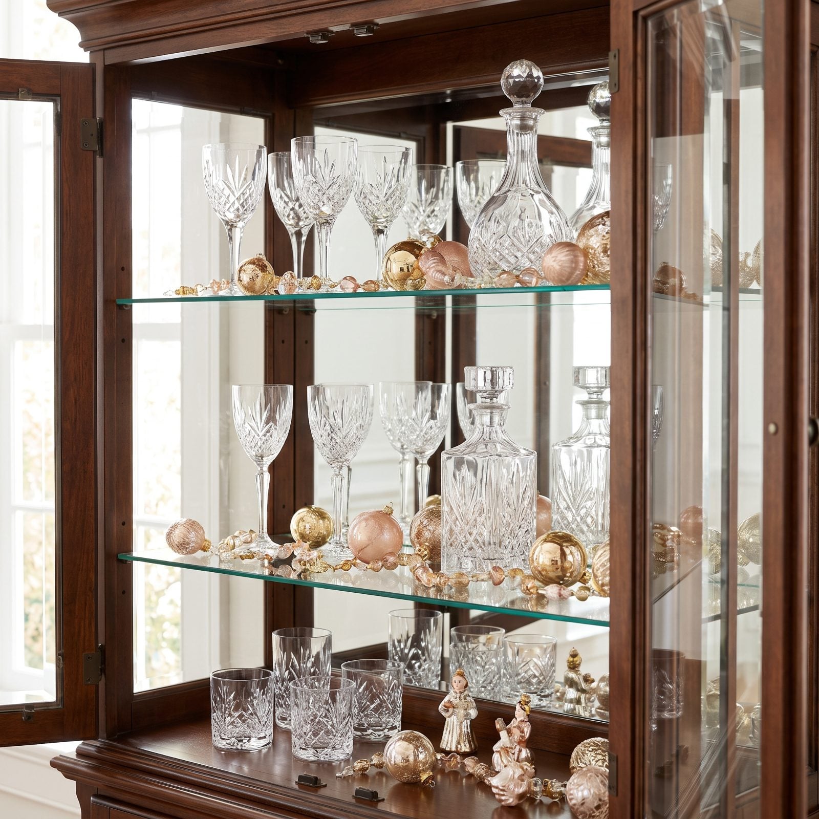A China Cabinet Displaying Ornaments Among the Glassware