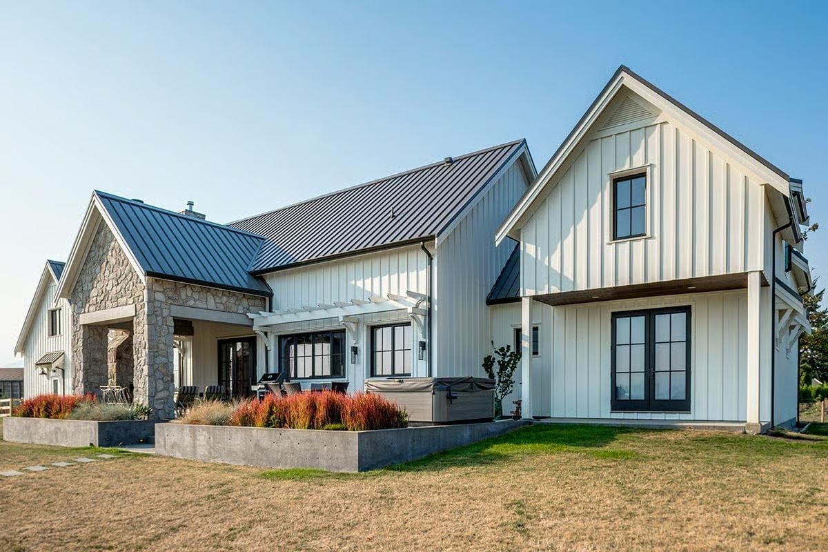 Board-and-Batten White with Stone Anchors and a Metal Roof That Means Business