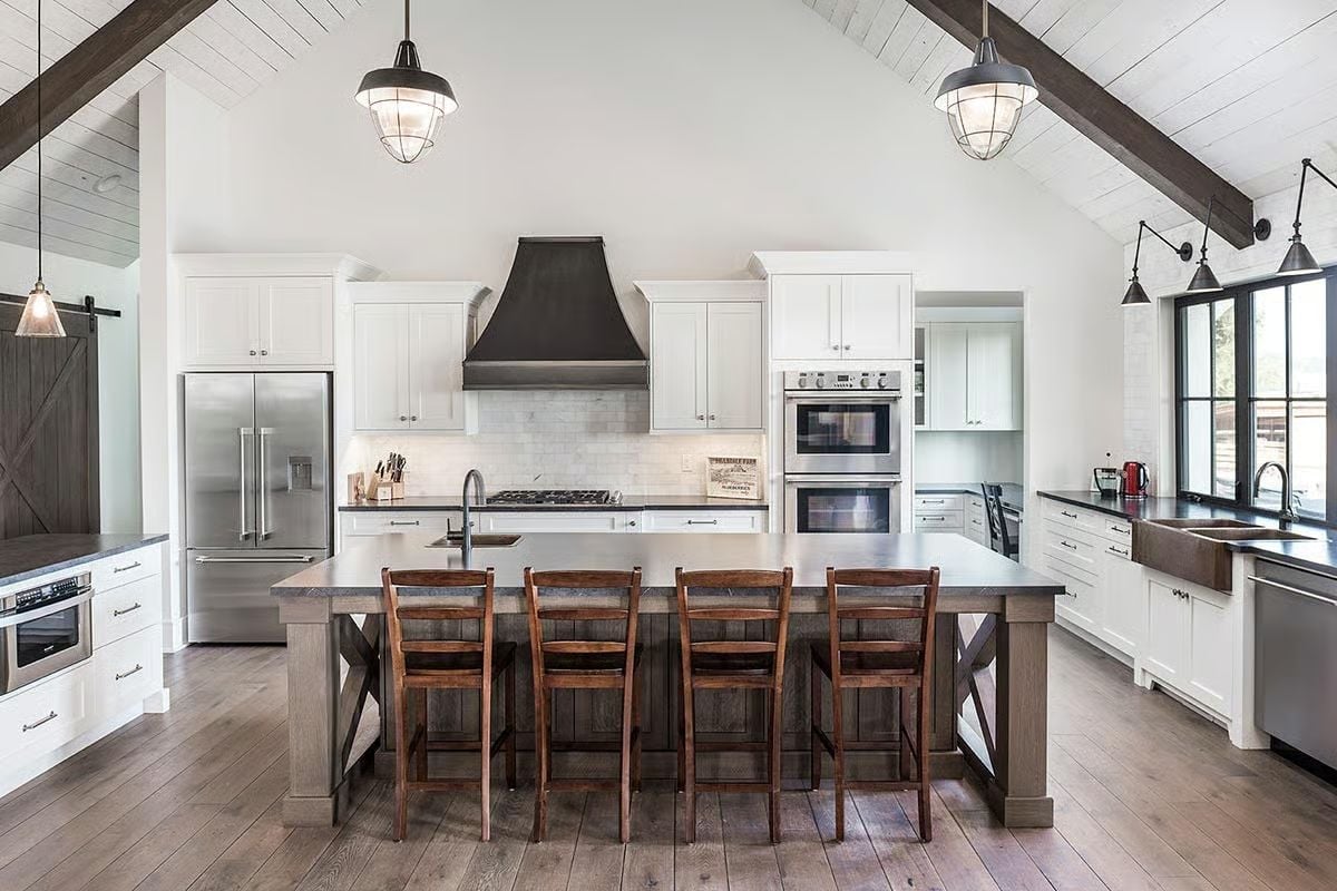 Vaulted Kitchen Where Dark Beams and White Cabinetry Split the Difference
