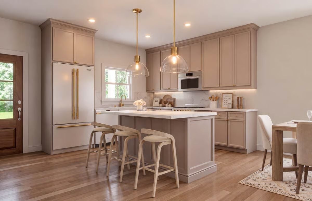 Warm Taupe Cabinets and Brass Hardware Make This Kitchen Feel Collected, Not Decorated