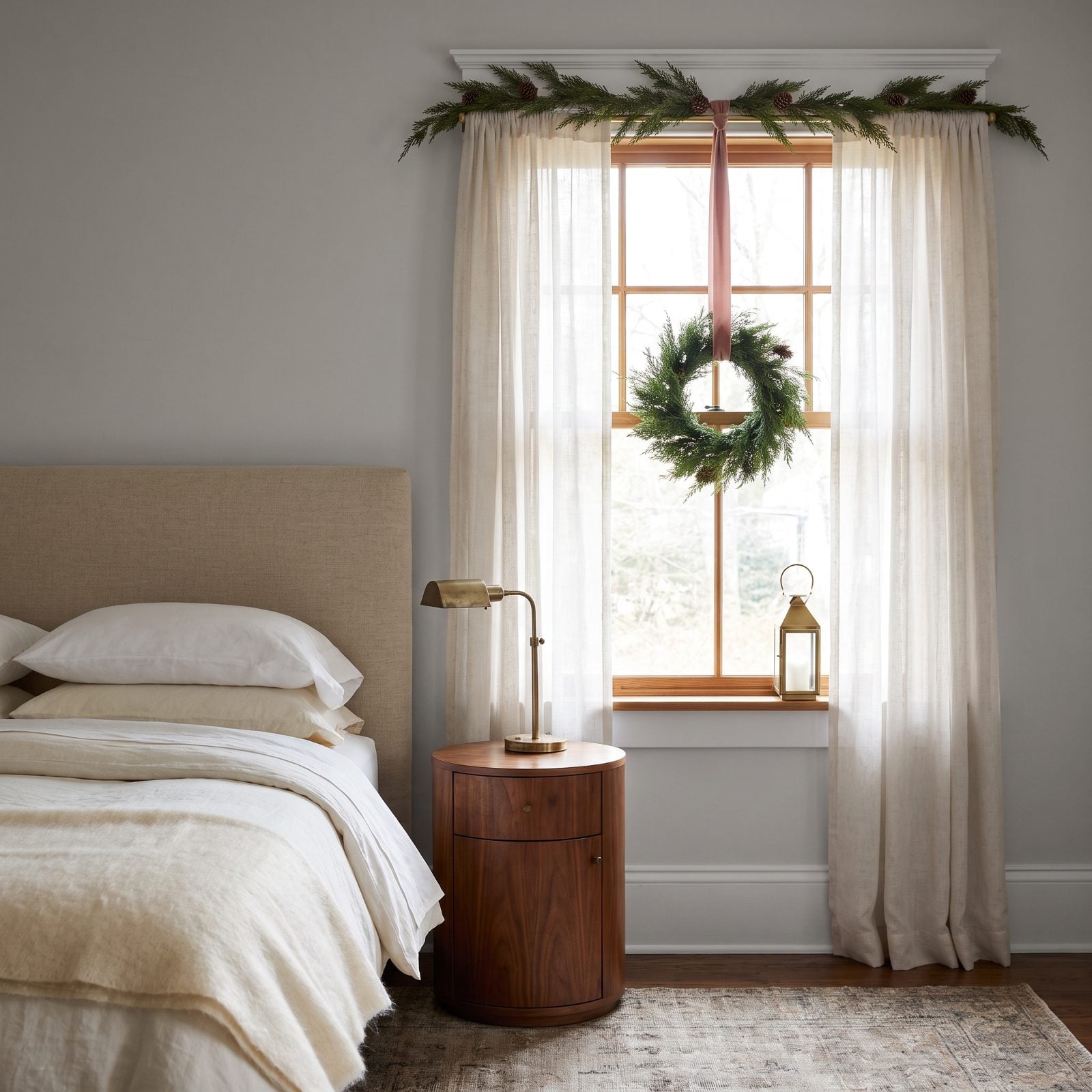 A Clear Nightstand Beside a Christmas-Dressed Window