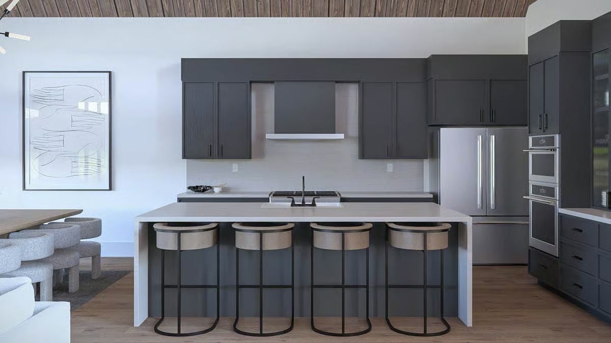 Dark Cabinetry and a Waterfall Island Keep This Kitchen Grounded and Functional