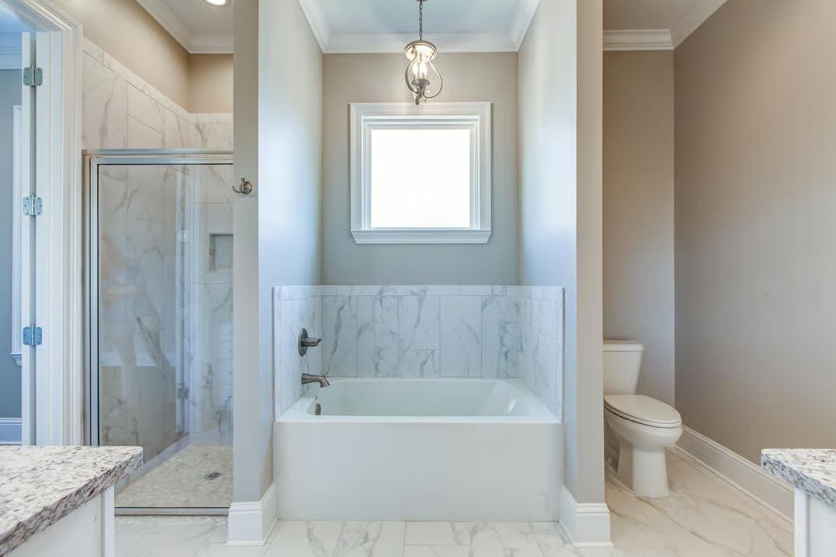 Marble Tile, a Soaking Tub, and a Pendant That Pulls It Together