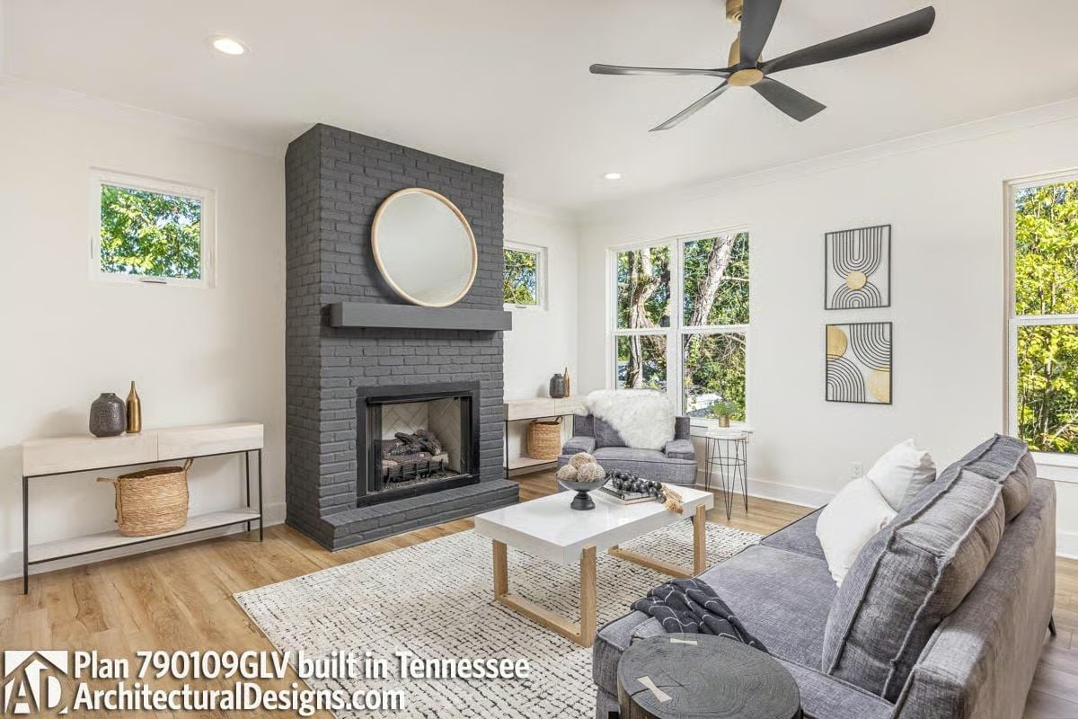 Dark Brick Floor-to-Ceiling, Round Mirror, and a Ceiling Fan That Earns Its Place