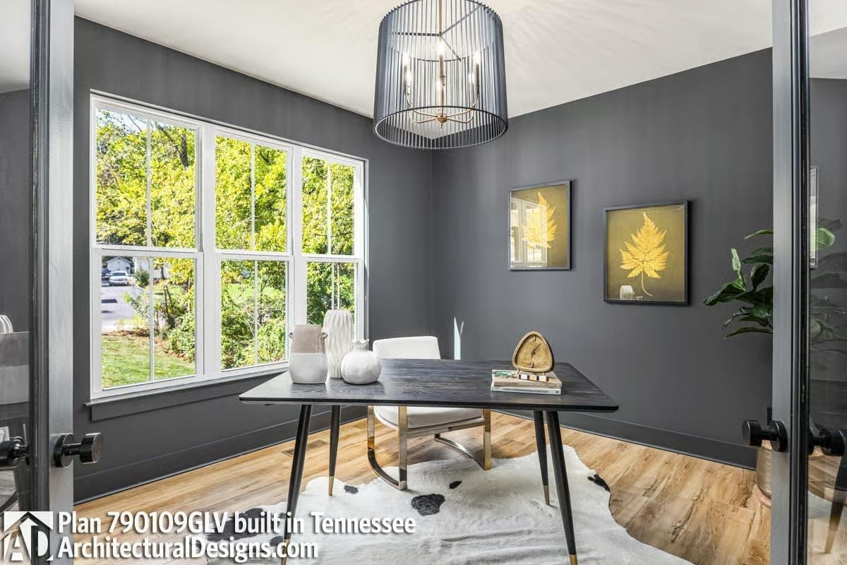 Slate Walls, a Wire Pendant, and Leaf Art That Repeats the Room's Own Logic