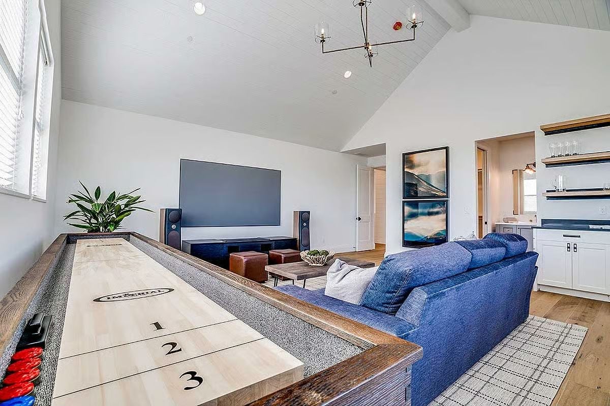 Shuffleboard, a Big Screen, and a Blue Sectional Built for a Crowd