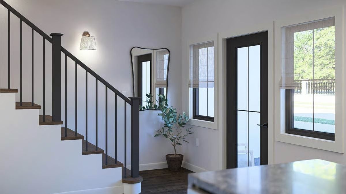 Dark Metal Railings and Wood Treads Set the Tone from the Moment You Walk In