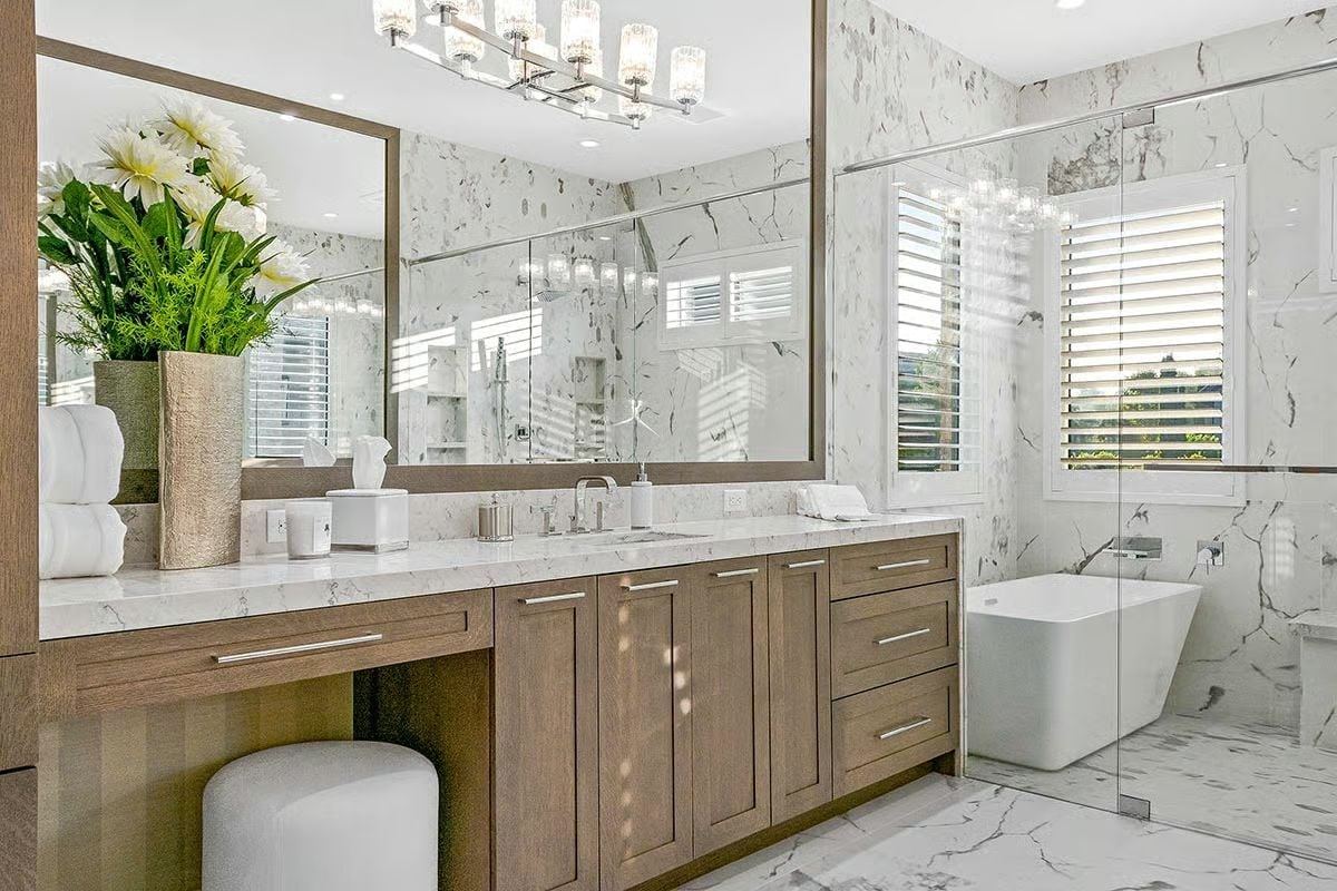 Marble Walls, a Freestanding Tub, and Vanity Cabinetry That Earns Its Keep