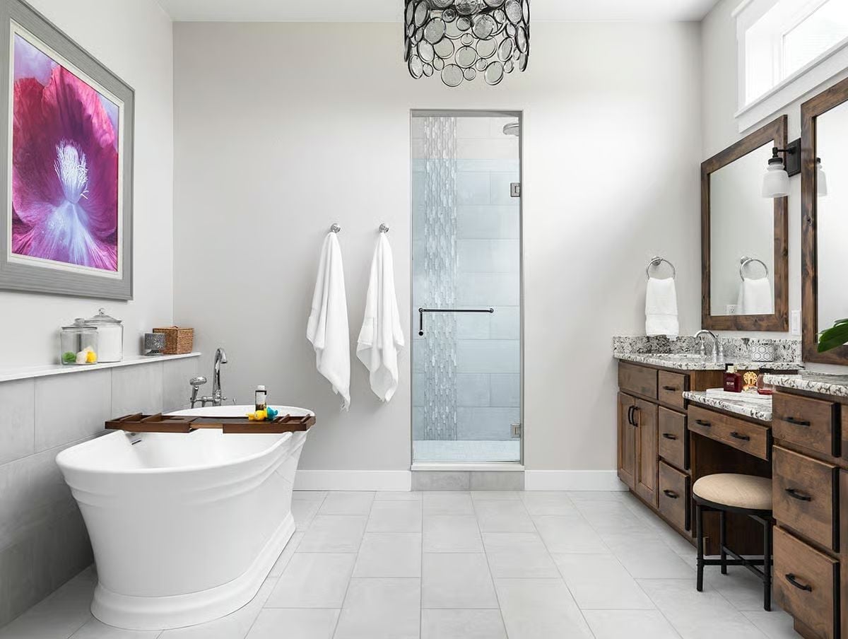Freestanding Tub, Wood Vanity, and a Chandelier That Has No Business Working This Well